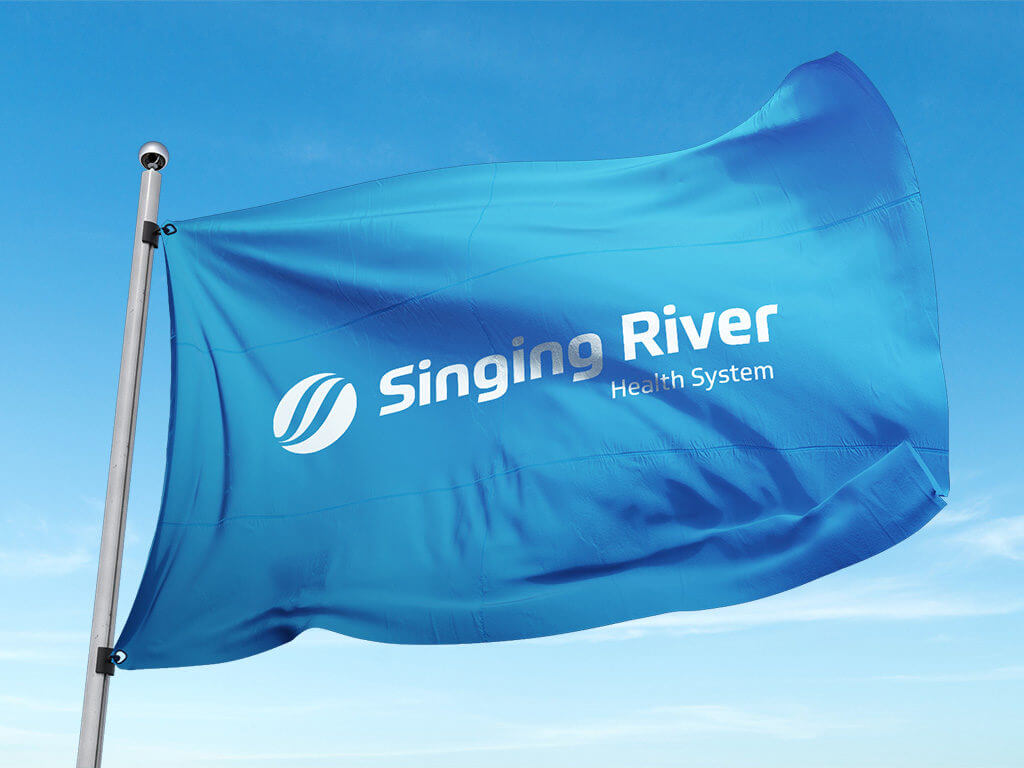 Waving flag with Singing River Health System logo displayed prominently