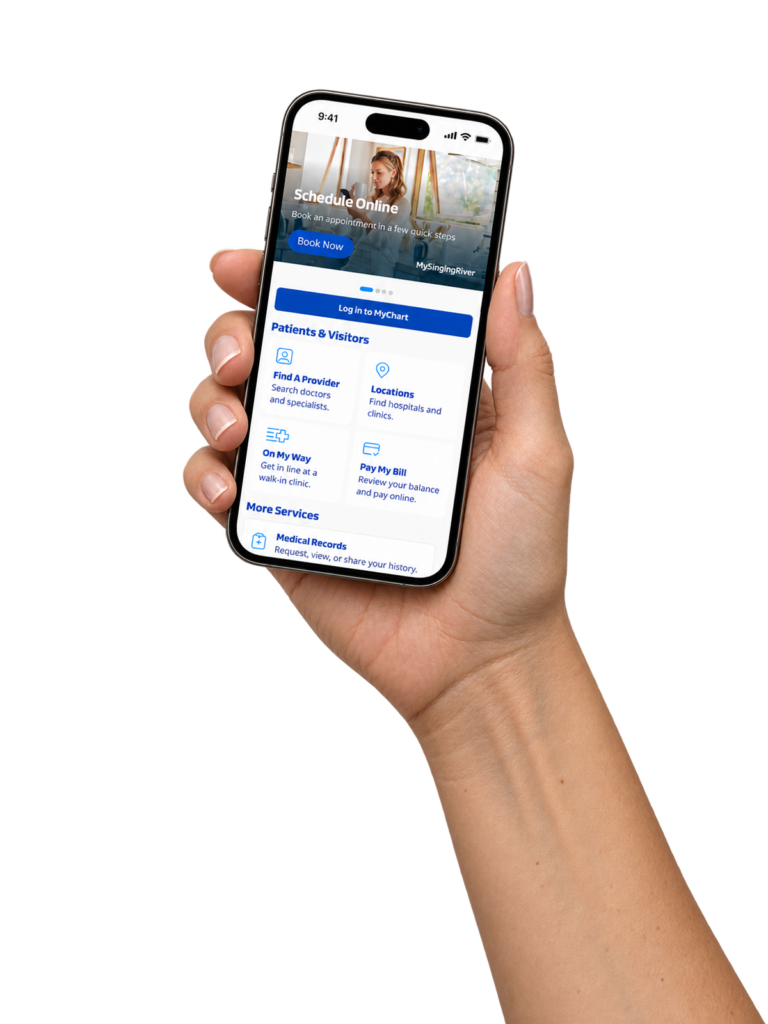 Hand holding iPhone displaying MySingingRiver app.
